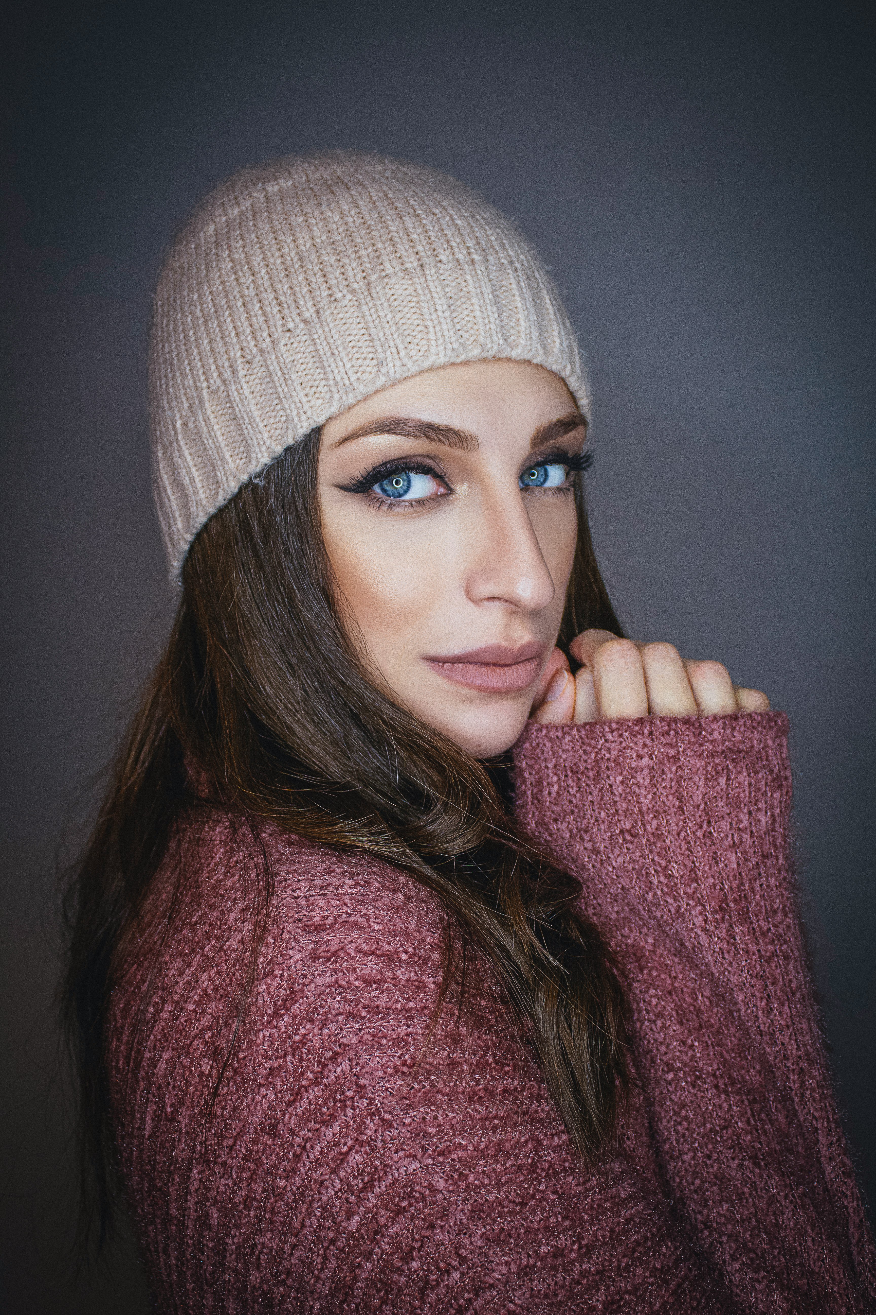 woman in white knit cap and red scarf